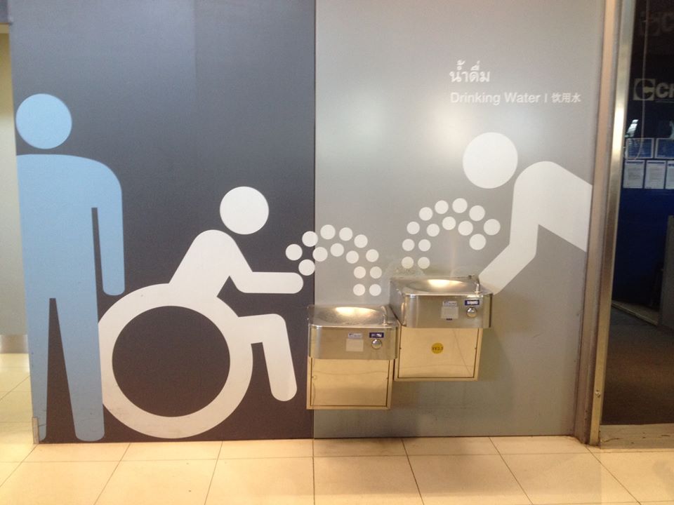 Photo of accessible icon wall graphic adjacent to accessible drinking fountain.